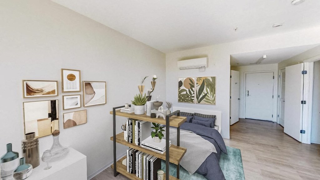 a bedroom with a bed and a bookshelf in front of it